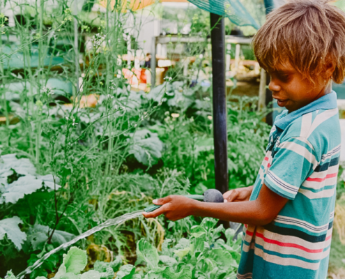 Indigenous Child Watering Plants